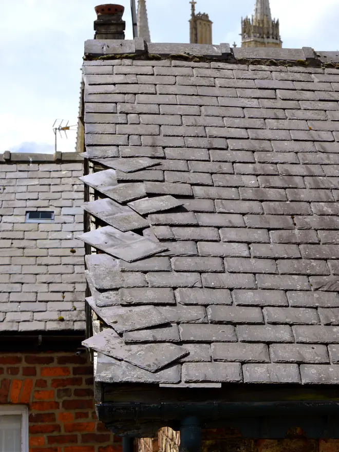 Slate roof with slates missing after a storm