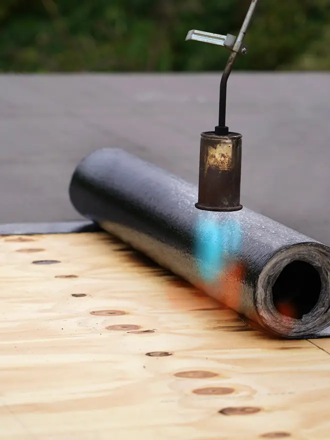 Felt roll being torched onto new decking
