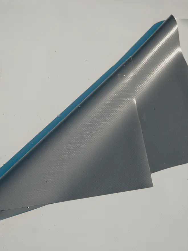 Rubber membrane lapped at a flat roof edge